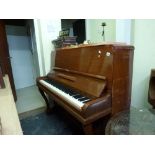 A mid 20th century upright piano by Phelps, London in a mahogany cabinet. WE DO NOT TAKE CREDIT