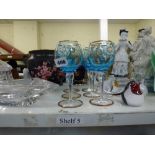 A shelf of glassware comprising a set of six Venetian blue glass wineglasses, four bird