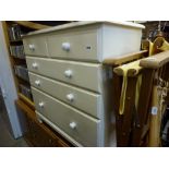 A modern chest of two small over three long drawers painted white and in the Victorian style and a