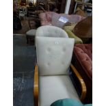 A 20th century television chair with buttoned cream fabric cover and bentwood arms. WE DO NOT TAKE