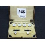 A part dress set of four buttons and two studs, in case, in 9 and 18 ct gold, and blue stones WE