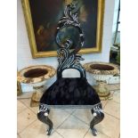 A dramatic hall chair in the style of Cruella de Vil with a rococo shaped back mounted with diamante