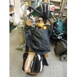 A set of golf clubs in bag with the name Taylor Made and two shooting sticks [end of third aisle] WE