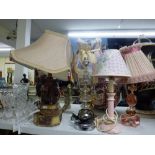 Eight decorative table lamps comprising a pair of pink glass lights with shades, a heavy brass and