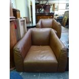 A pair of modern armchairs upholstered in brown leather. WE DO NOT TAKE CREDIT CARDS OR CASH.