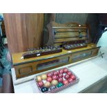 An E J Riley Snooker Scoreboard, a cue stand and grips, a cabinet of balls, a rest and a cardboard