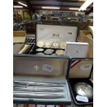 A collection of crowns in a fitted box by Harrington & Byrne along with five modern £5 coins and a