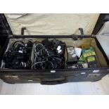 A vintage suitcase containing multiple phone chargers, two transistor radios, Statewide and