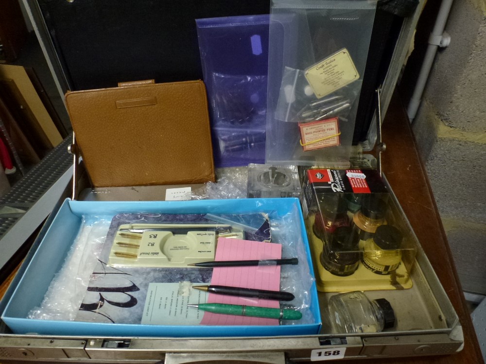 A document case containing calligraphy pens and inks and a box of educational instruction books.