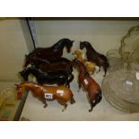 Five large Beswick horses including an unglazed Black Beauty, a palomino, an unglazed bay horse