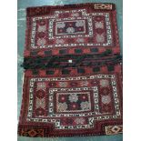A large and traditional camel bag with traditional motifs on a red ground [floor by rostrum] WE DO