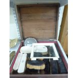 A collection of old tortoiseshell- and ivory-backed brushes, a small tray, hand mirror and combs, in