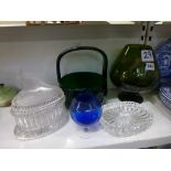 A collection of glassware including a large green glass vase, a green glass basket, two clear