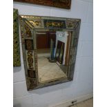 Two Continental rectangular bevel-edged mirrors in highly decorative deep raised frames WE DO NOT