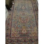 A pair of Persian carpets of traditional design with cream ground decorated throughout with