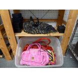 A black leather MCM handbag with applied stud and badge decoration, a pink snake skin MCM handbag,
