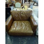 A spectacular leather armchair in good quality brown leather with studded decoration and a broad