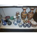 A shelf of mainly Oriental ceramics, including a Chinese blue and white double gourd bottle with