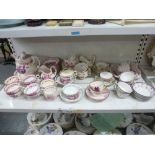 A shelf of English pink lustre crockery, early 19th to early 20th century, comprising a tea