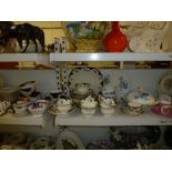 Three shelves of 19th century and later tea services including Oriental, Calyx ware, Tuscan china,