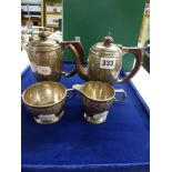 An attractive George V silver four-piece bachelor tea service, by Mappin & Webb, with brown handles,