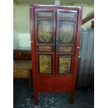 An attractive Chinese cabinet in red lacquer the pair of doors painted with domestic scenes above