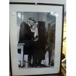 A large framed photographic image of Ray Charles at the piano (100 x 65 cm), framed WE DO NOT TAKE