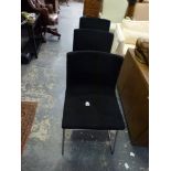 Three contemporary IKEA Bernhard dining chairs with black fabric covers on stainless steel supports.