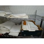 Two shelves of good quality vintage table linen, mainly linen and cotton damask, including large