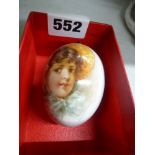 A late Continental porcelain egg-shaped scent bottle, with brass stopper, well painted with a