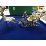 A charming Elizabeth II silver sweetmeat basket as a rococo sleigh with gilt interior pulled by a