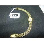 An Accurist 'Gold' lady's wristwatch, in 9 ct, on integral bracelet, quartz movement, 19.3 gm