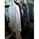 A small collection of ladies' coats including a long cream NAF NAF coat, a cropped sheepskin jacket,