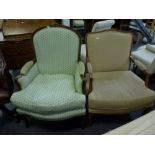 Two reproduction French style bergeres one with a carved frame and green fabric cover, the other a