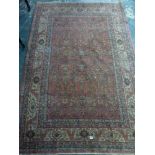 A classical Persian rug of fine quality the red ground decorated with stylised flowers within a