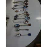 A collection of 17 silver souvenir spoons, English and foreign, many enamelled, also a few