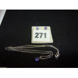 A modern 18 ct white gold necklet hung with a single stone tanzanite pendant, and a pair of matching