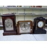 Three mantel clocks, comprising: a French late 19th century slate timepiece; a Junghans clock, early