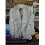 A lady's pearl-coloured and spotted fox fur coat, with beige suede inset strips, shawl collar and