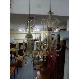 A good pair of early 20th century glass ceiling chandeliers each of six arms with scrolling tops,