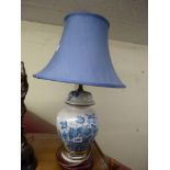 A pretty blue and white ginger jar and cover converted to electricity on wooden stand with blue