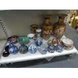 A shelf of mainly Oriental ceramics, including a Chinese blue and white double gourd bottle with