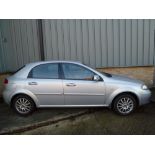 A silver Chevrolet Lacetti SX petrol car registration number LM06 LCZ. We have the keys and log