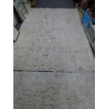 A pair of large rugs each with a cream shag pile (each 8 x 5 ft 6 in approximately) [shelves by