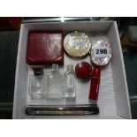 A Dunhill compact within a red leather case, two other compacts, three empty scent bottles including