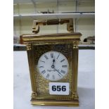 A modern brass carriage timepiece from Mappin & Webb Ltd with scroll-pierced mask [A] WE DO NOT TAKE