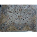 A handmade rug of good quality the cream made ground decorated with floral decoration with a broad