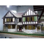 A Lines Bros Ltd (Tri-Ang) painted wooden dolls' house, 1930/40s, in 'Stockbroker Tudor' style 93