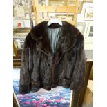 A lady's dark brown mink fur jacket with collar and front pockets, concealed single fastening [