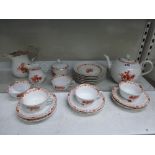 A modern Meissen tea service, for six (lacking one tea cup), decorated with flowers in orange and